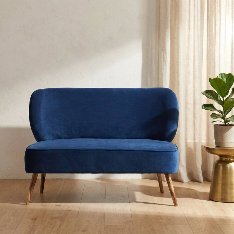 Navy blue velvet 2 seater settee in a styled living room