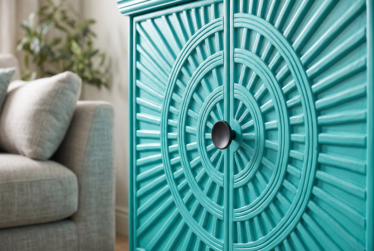 Close-up of the hand-carved sunburst door panel and knob