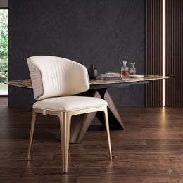 Cream leather dining chair with champagne gold legs in a luxury dining room