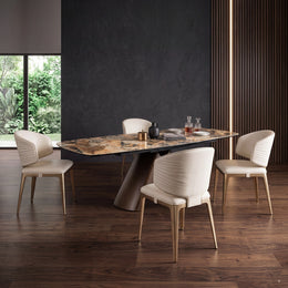 Four cream leather dining chairs around a luxury stone-top dining table