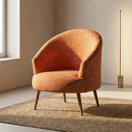 Rust orange accent chair beside a bookshelf
