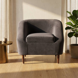 Charcoal grey velvet lounge chair in a modern living room