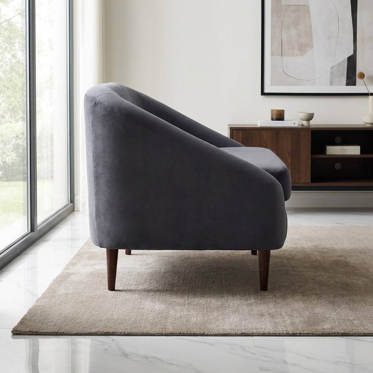 Charcoal velvet lounge chair in a study corner