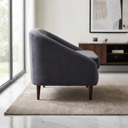 Charcoal velvet lounge chair in a study corner