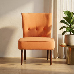 Orange tufted slipper chair in a bright living room