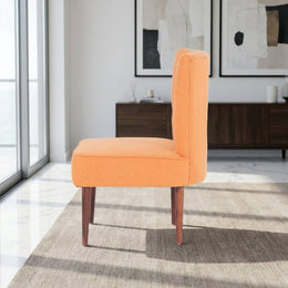 Orange slipper chair in a bedroom corner