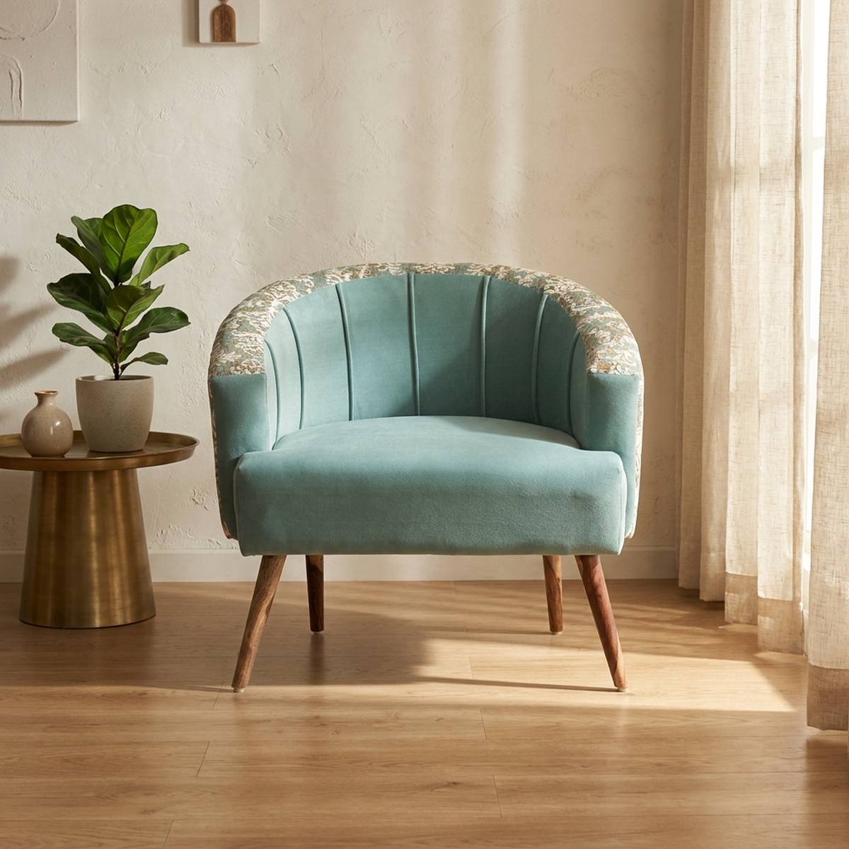 Teal velvet barrel accent chair in a styled living room