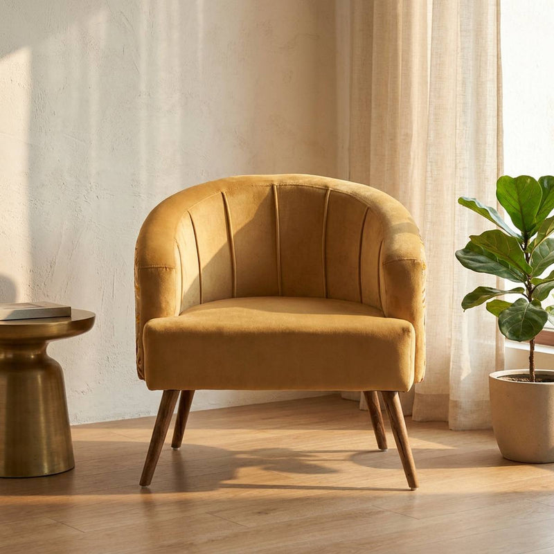 Mustard yellow velvet barrel accent chair in a living room