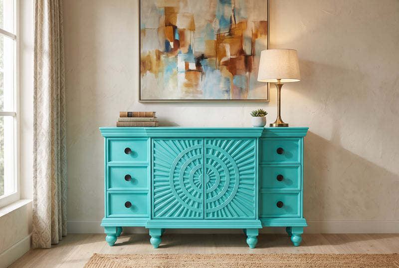 Turquoise carved sunburst sideboard styled in a modern living room