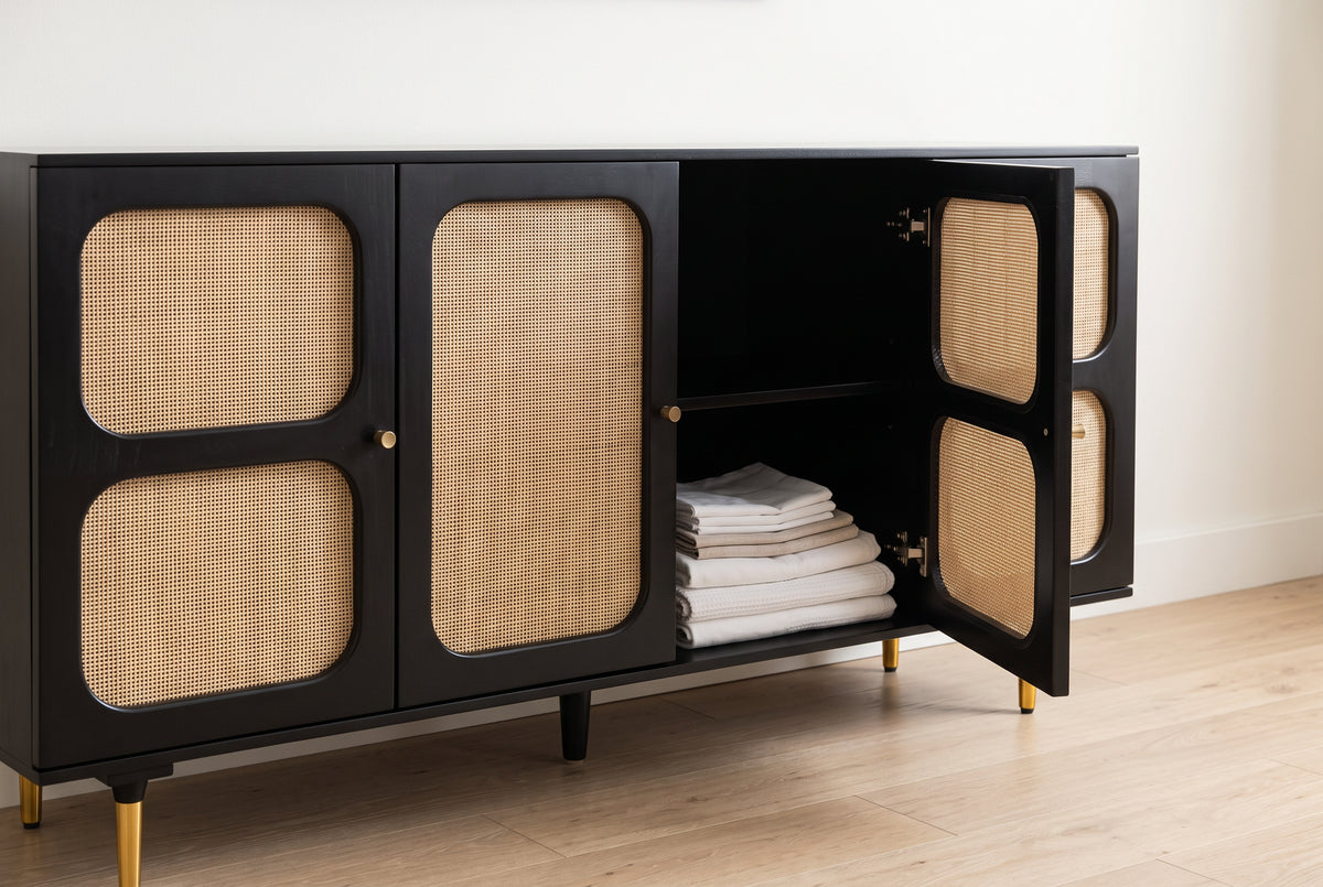 Cane sideboard with one door open showing folded linen inside