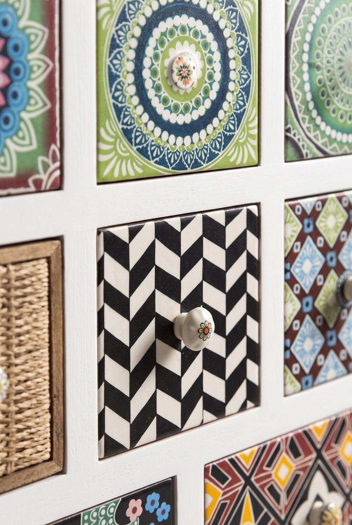 Close-up of printed tile drawer fronts and ceramic knobs