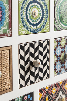Close-up of printed tile drawer fronts and ceramic knobs